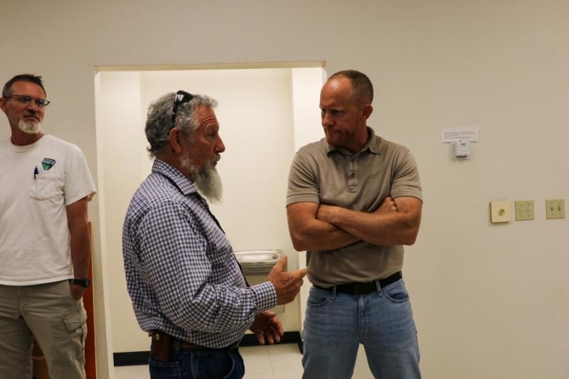 Two men speaking to each other.