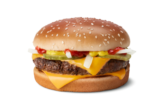 Image of cheeseburger on a sesame bun with pickles, onions, and ketchup.