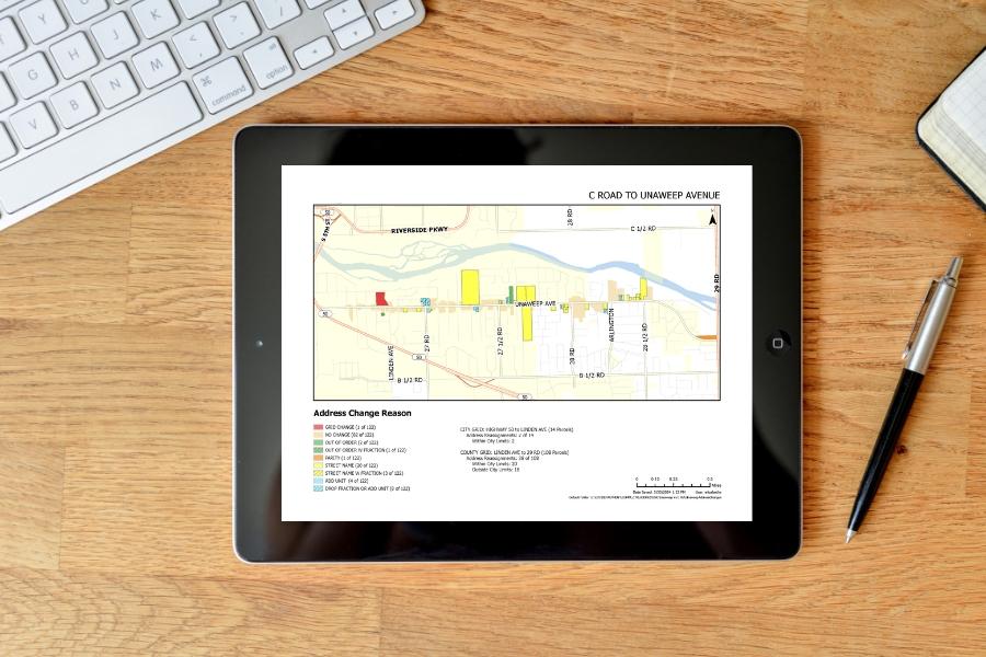 Desk with keyboard and iPad displaying a colorful map in Mesa County, CO.
