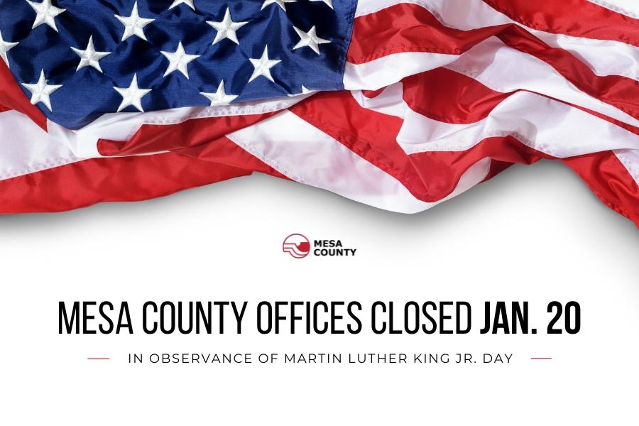 Red and black Mesa County logo and black text reading, "Mesa County Offices Close Jan. 20 in observance of Martin Luther King Jr. Day," below the American flag. 