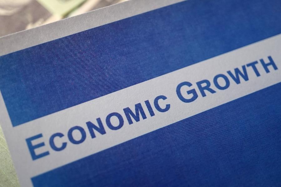 Blue folder with white rectangle in middle and blue text reading, "Economic Growth."
