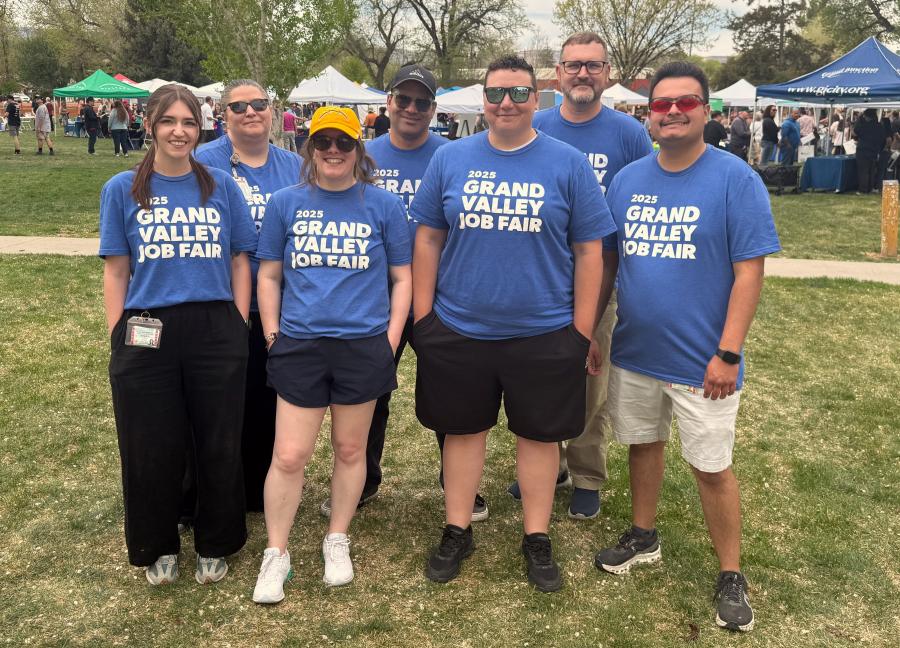 Employment Services team posing for a group picture in the park.