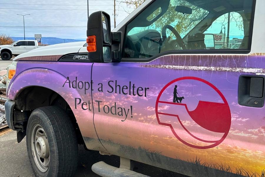 A truck with text on the side reading, Adopt a Shelter Pet Today!